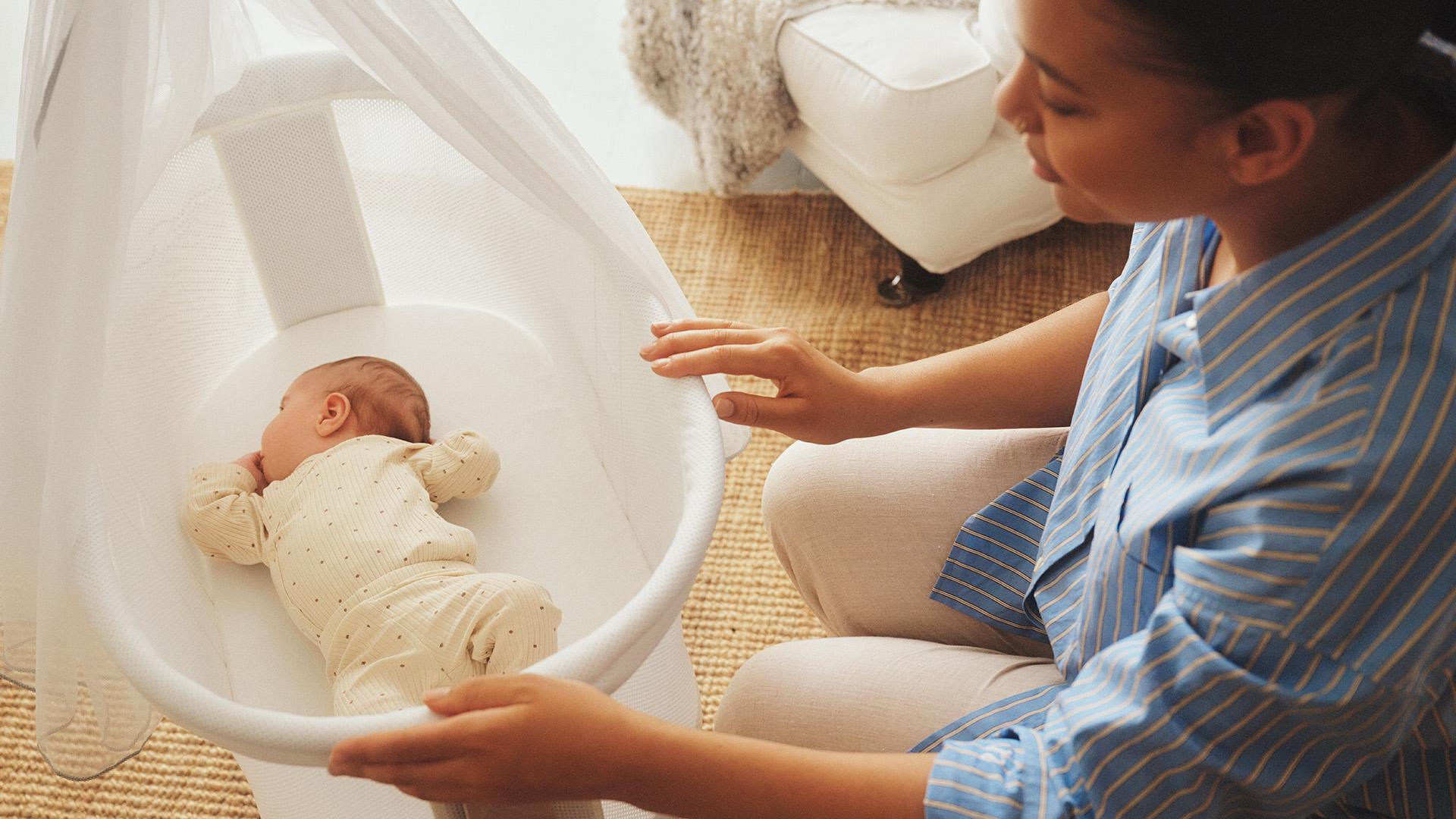 White mesh cradle with canopy, mum and baby